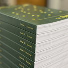 Image of green bound books produced by the University Reprographics Centre