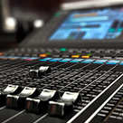 Image of audio equipment, sliders on an audio desk