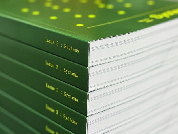 Image of green bound books produced by the University Reprographics Centre