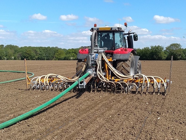 Tractor in a field pulling along a Trailing Shoe